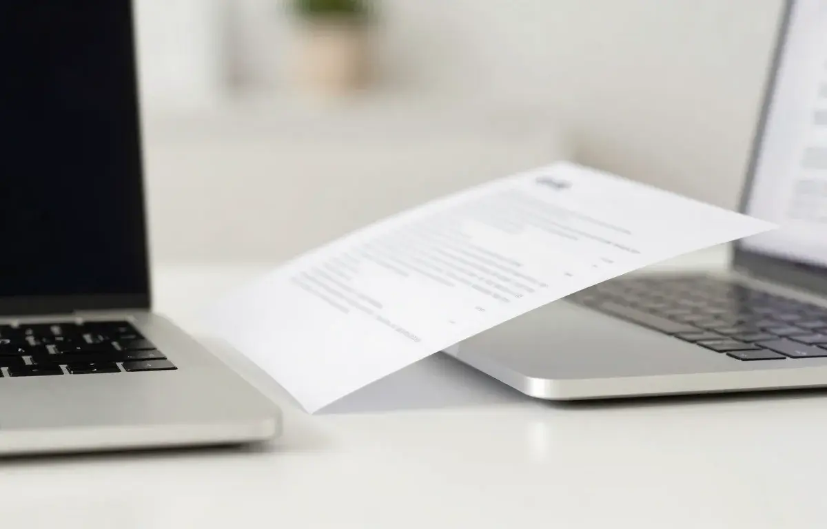 Fax app on a phone next to a laptop showing an online fax service