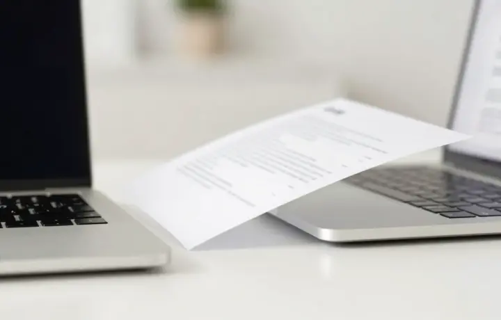 Fax app on a phone next to a laptop showing an online fax service