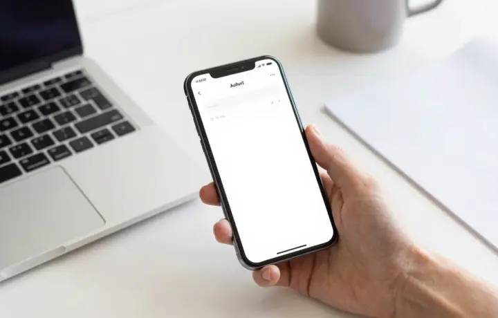 Person sending a free fax from an Android phone on a bright desk